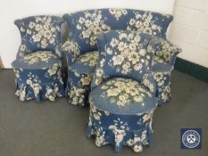 An early 20th century three piece lounge suite in blue floral covering