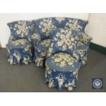 An early 20th century three piece lounge suite in blue floral covering