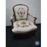 A continental walnut armchair on cabriole legs in tapestry fabric