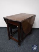 An oak gate leg table and an occasional table