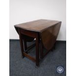 An oak gate leg table and an occasional table