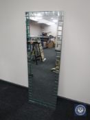A contemporary all glass hall mirror