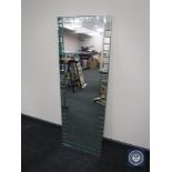 A contemporary all glass hall mirror