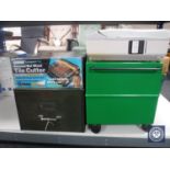 A plastic portable storage box together with a boxed tile cutter,