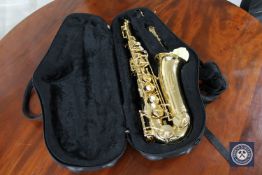 A brass Alpha Saxophone by Trevor James in a fitted case