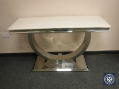 A contemporary polished steel console table with white polished stone top,