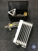 A metal tool box containing screws, car jack,