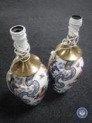 A pair of Imari pattern porcelain table lamps with continental wiring