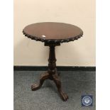 A reproduction mahogany tilt topped occasional table