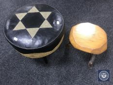 A circular leather footstool and a rustic milking stool