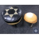 A circular leather footstool and a rustic milking stool