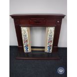 A mahogany effect fire surround with tiles