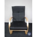 A black leather beech framed armchair