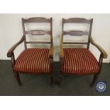 A pair of mahogany 20th century armchairs in red striped fabric