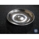 An Arts and Crafts style hammered metal bowl, diameter 26 cm.