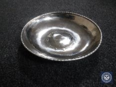 An Arts and Crafts style hammered metal bowl, diameter 26 cm.