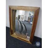 A contemporary mango wood wall mirror and a driftwood & metal yacht