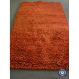 A hand knotted rug, shaggy rust, 180 cm x 270 cm, rrp £681.00.