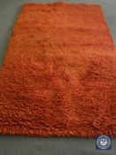 A hand knotted rug, shaggy rust, 180 cm x 270 cm, rrp £681.00.