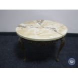 A marble effect circular coffee table on metal legs