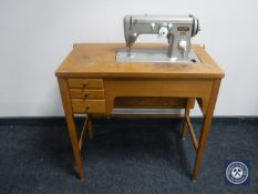 A mid 20th century Pfaff electric sewing machine in table CONDITION REPORT: There