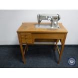 A mid 20th century Pfaff electric sewing machine in table CONDITION REPORT: There