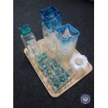 A tray of two-tone glass decanter together with twelve matching glasses and three vases