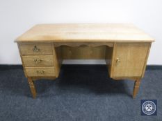 A continental oak twin pedestal writing desk