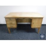 A continental oak twin pedestal writing desk