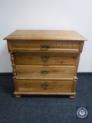 A 19th century pine four drawer chest on bun feet