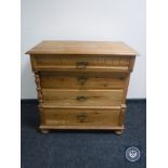 A 19th century pine four drawer chest on bun feet