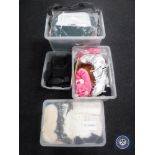 Four plastic storage boxes containing shoes,