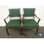 A pair of mid 20th century armchairs in green fabric