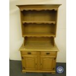 A pine effect kitchen dresser and set of pine open bookshelves