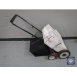 An Eckman multi-function lawn mower / scarifier / rotorvator and accessories