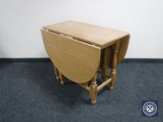 A continental oak drop leaf table and four chairs