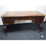 An antique mahogany leather topped writing desk fitted five drawers