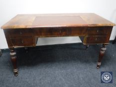 An antique mahogany leather topped writing desk fitted five drawers