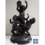 A large reproduction bronze figure of three putti, on marble base,