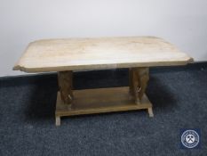 A two tier coffee table on elephant supports