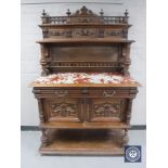 A 19th century continental mahogany marble topped buffet backed sideboard