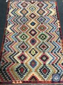 An Afghan wool rug,