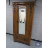 An Edwardian oak Arts and Crafts mirror door wardrobe CONDITION REPORT: Width 88cm.