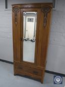 An Edwardian oak Arts and Crafts mirror door wardrobe CONDITION REPORT: Width 88cm.