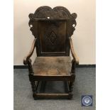 A carved oak Wainscot style armchair,