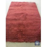 A hand knotted rug, shaggy maroon, 180 cm x 270 cm, rrp £681.