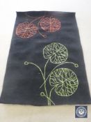 A hand tufted rug, floral black, 120 cm x 180 cm, rrp £297.00.