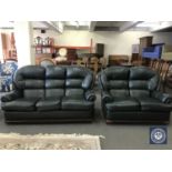 A green leather three-piece suite comprising three seater settee,