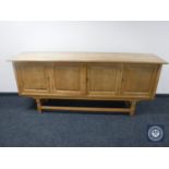 A continental oak four door low sideboard