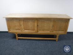 A continental oak four door low sideboard